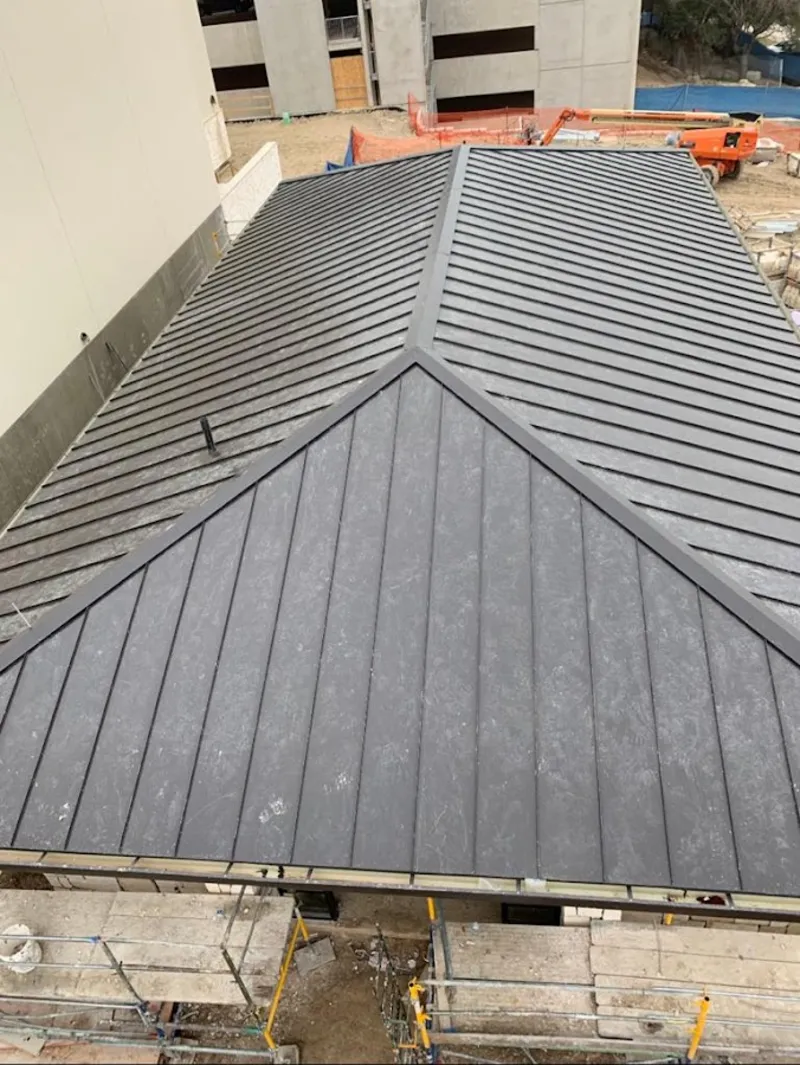 Commercial metal roof construction with crane equipment in Sidney